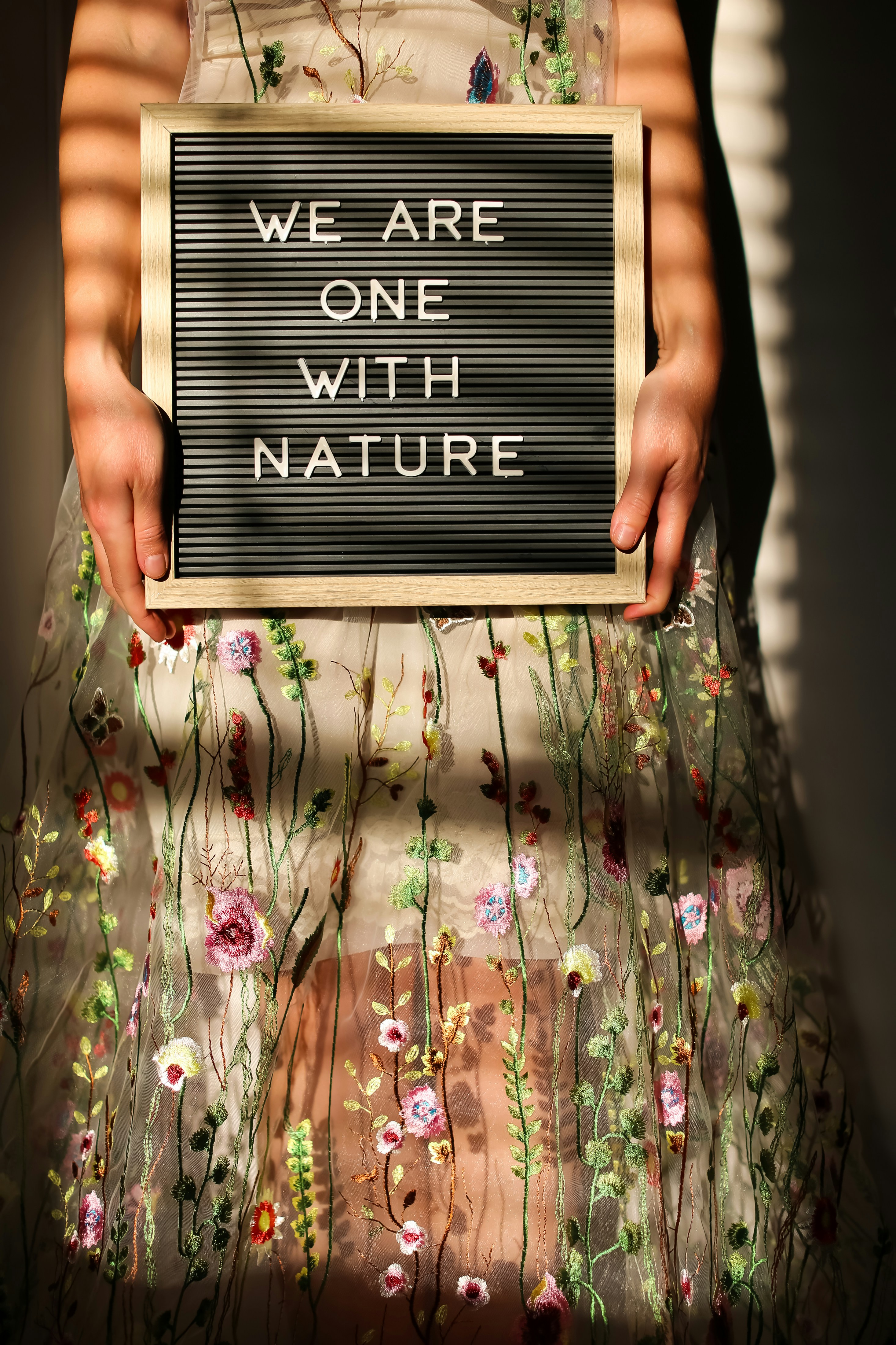 a person holding a black sign