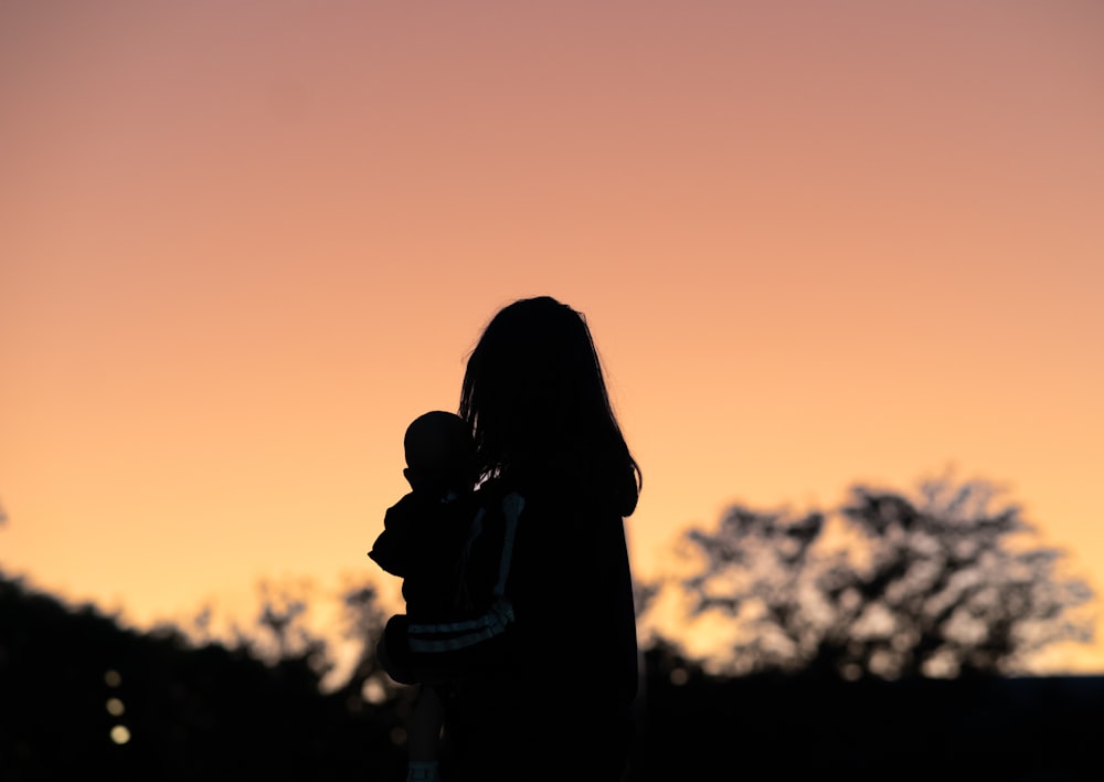 silhouette of a person and child