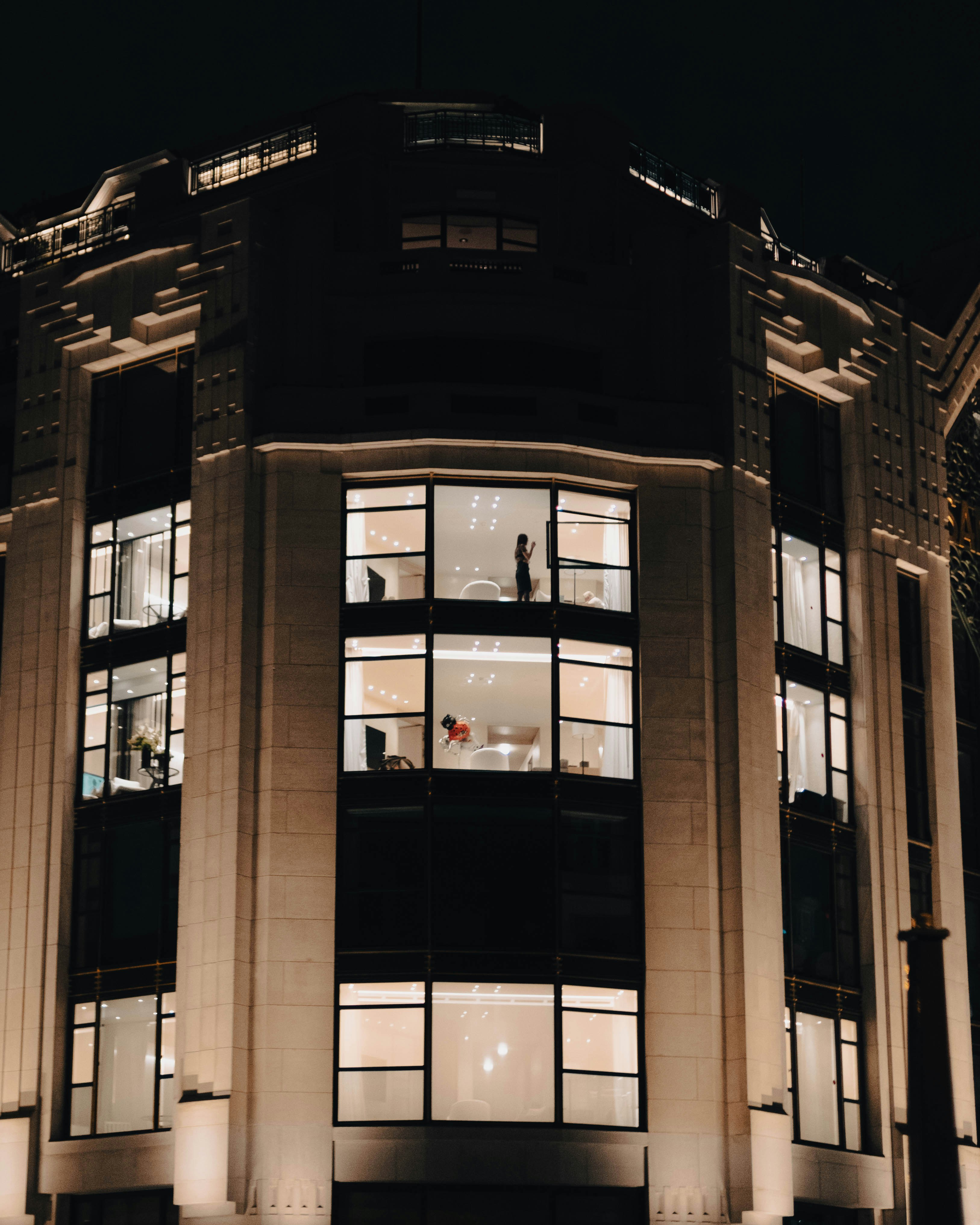 a building with windows and a person standing in the window