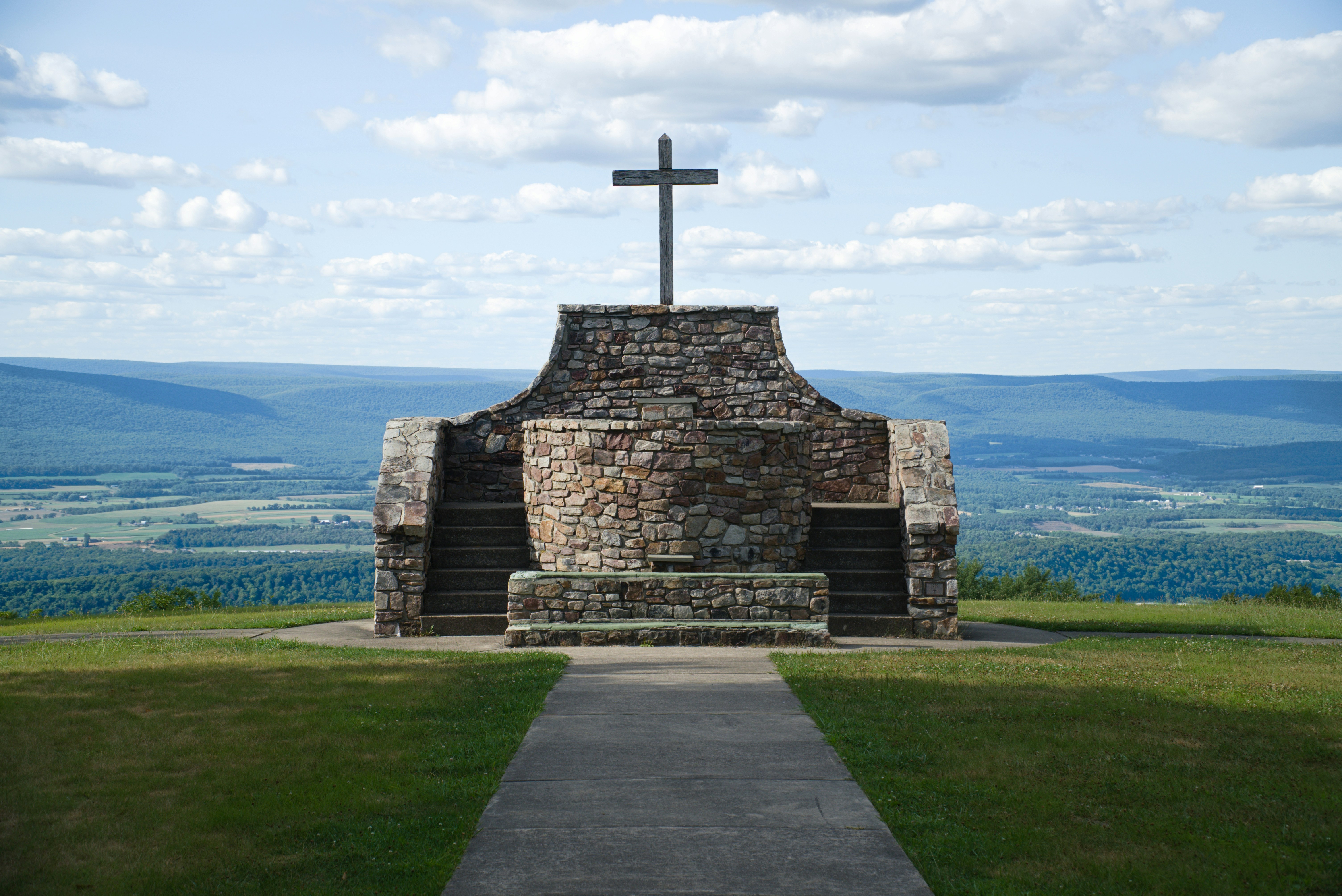 a stone building with a cross on top