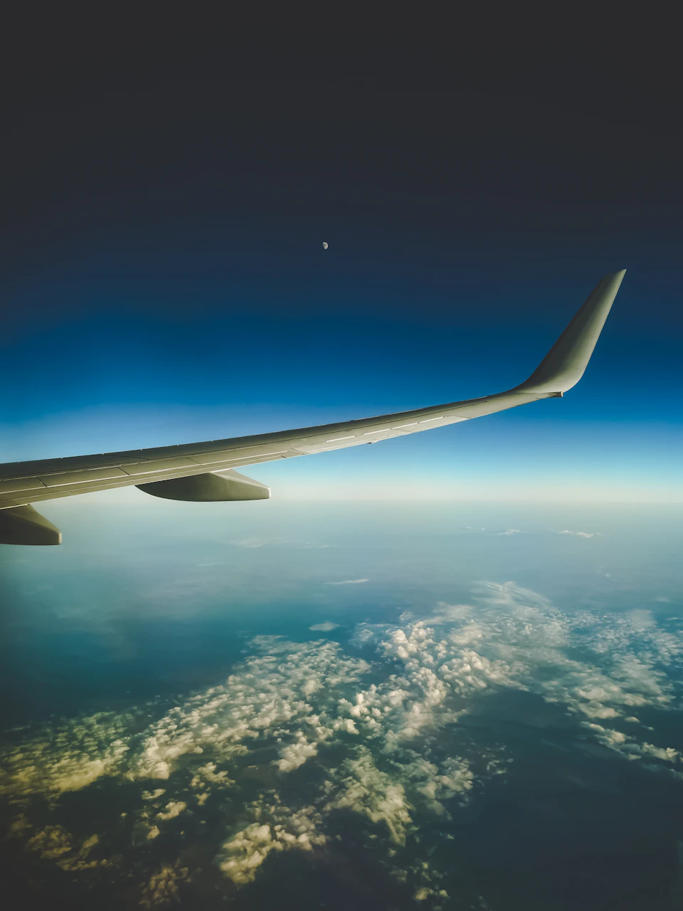 Airplane wing extends from left to right, partially visible on the right side horizon
