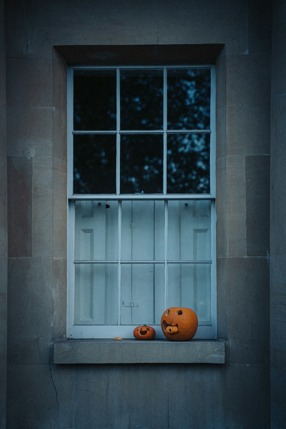 a window with carved pumpkins