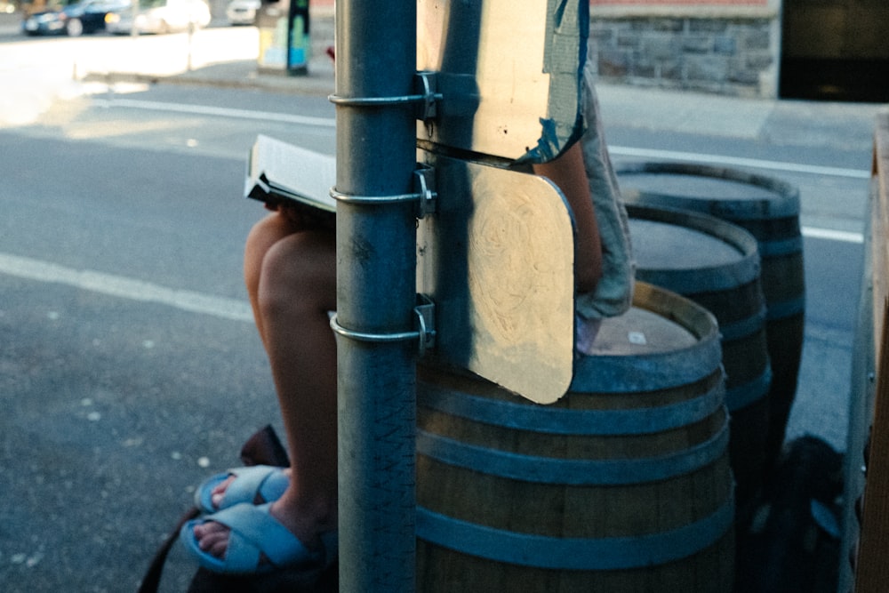 a person sitting on a pole