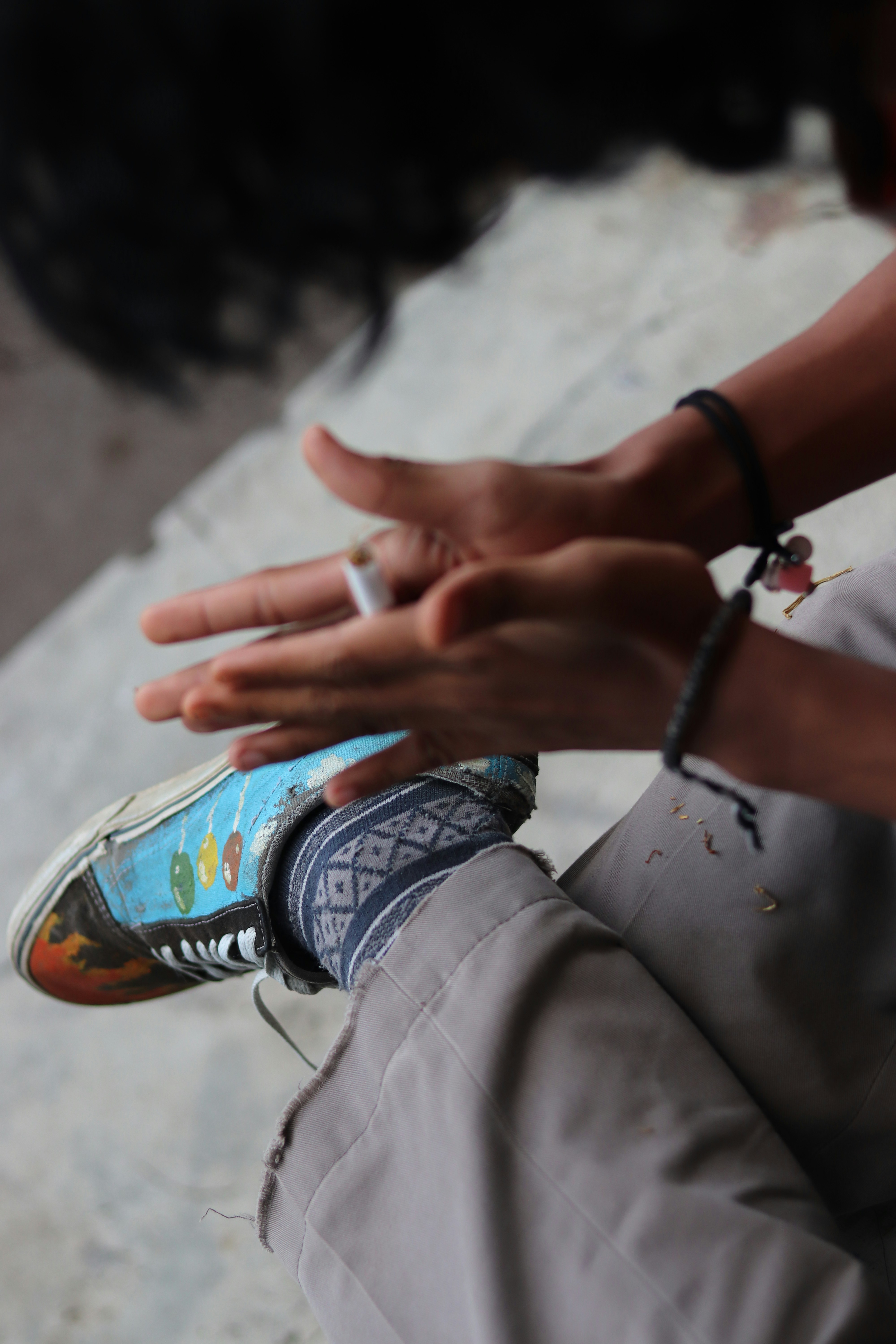 A person holding a cigarette in their hand