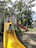 A joyful child climbing colorful playground equipment under supervision.