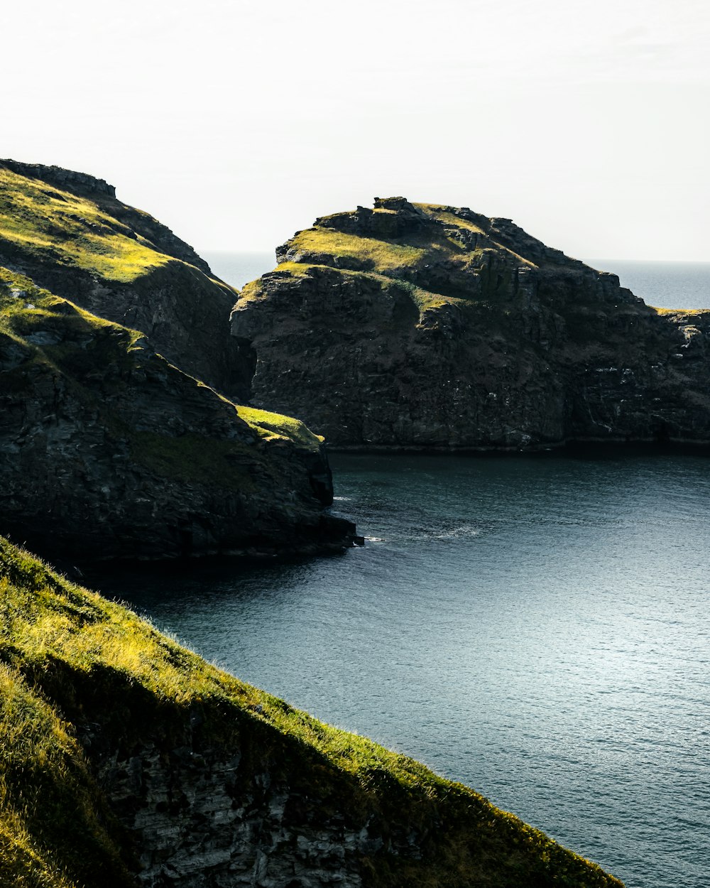 a cliff with a body of water below