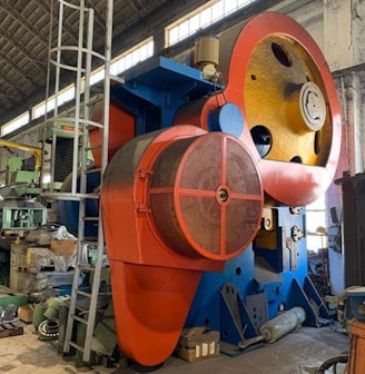 a large red and white machine in a factory
