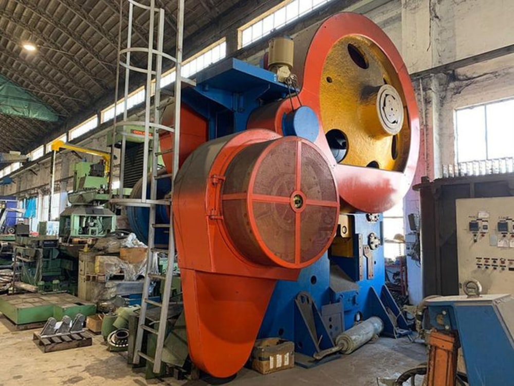 a large red and white machine in a factory