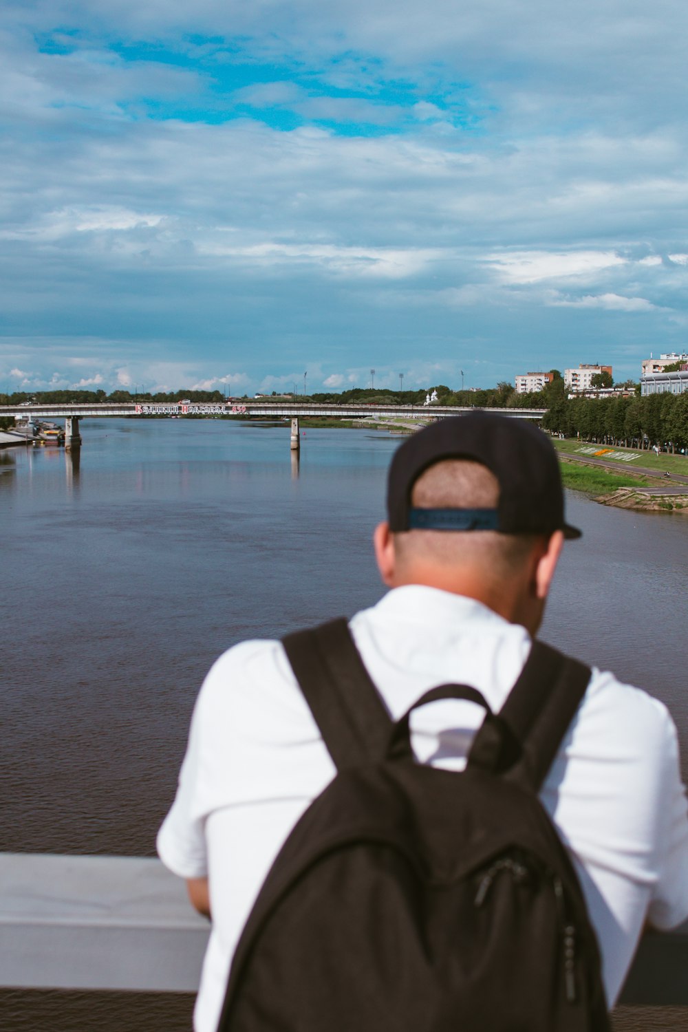 a person in a hat looking at a body of water