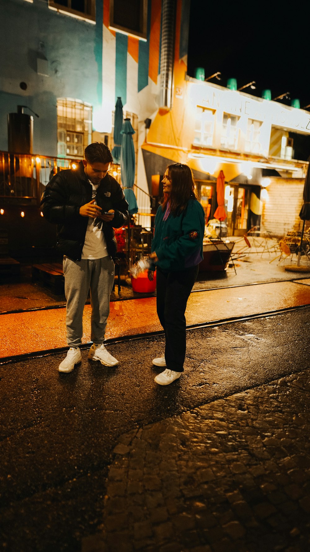 a man and a woman standing on a street corner