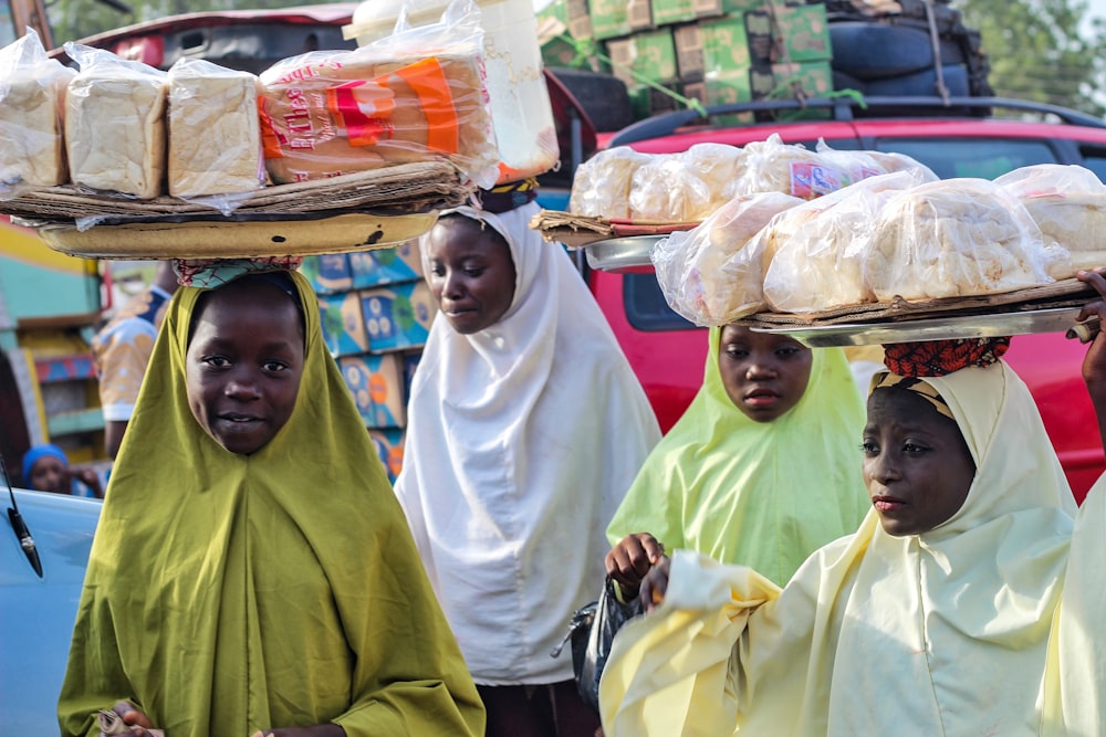 a group of women carrying food