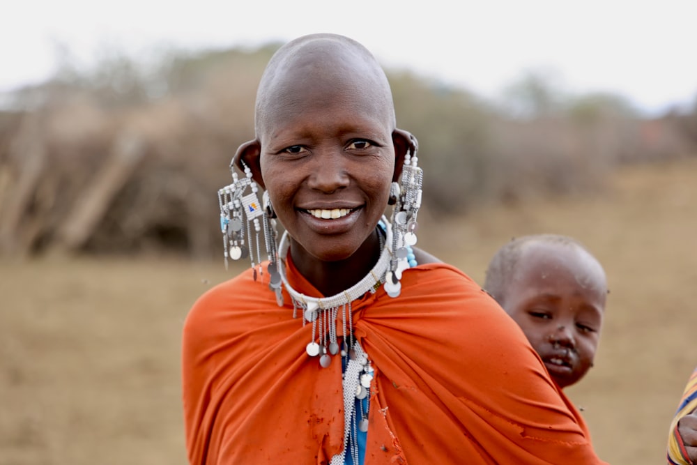 a woman smiling with a man behind her