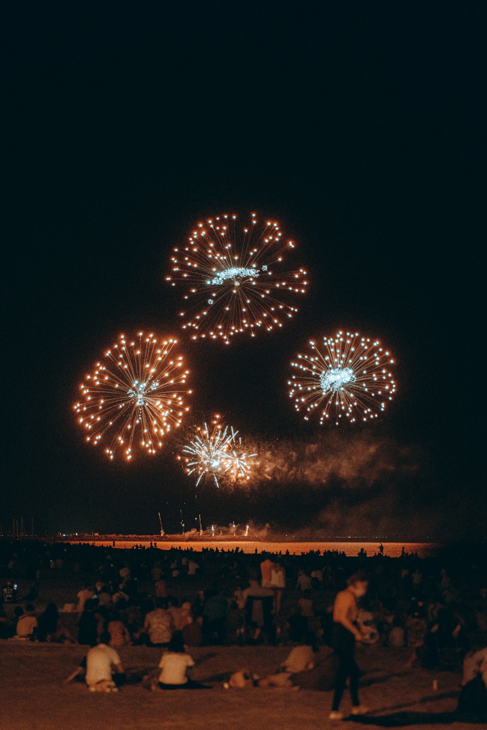 a group of people watching fireworks