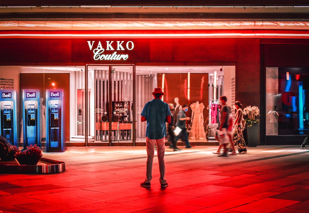 a person walking in front of a storefront