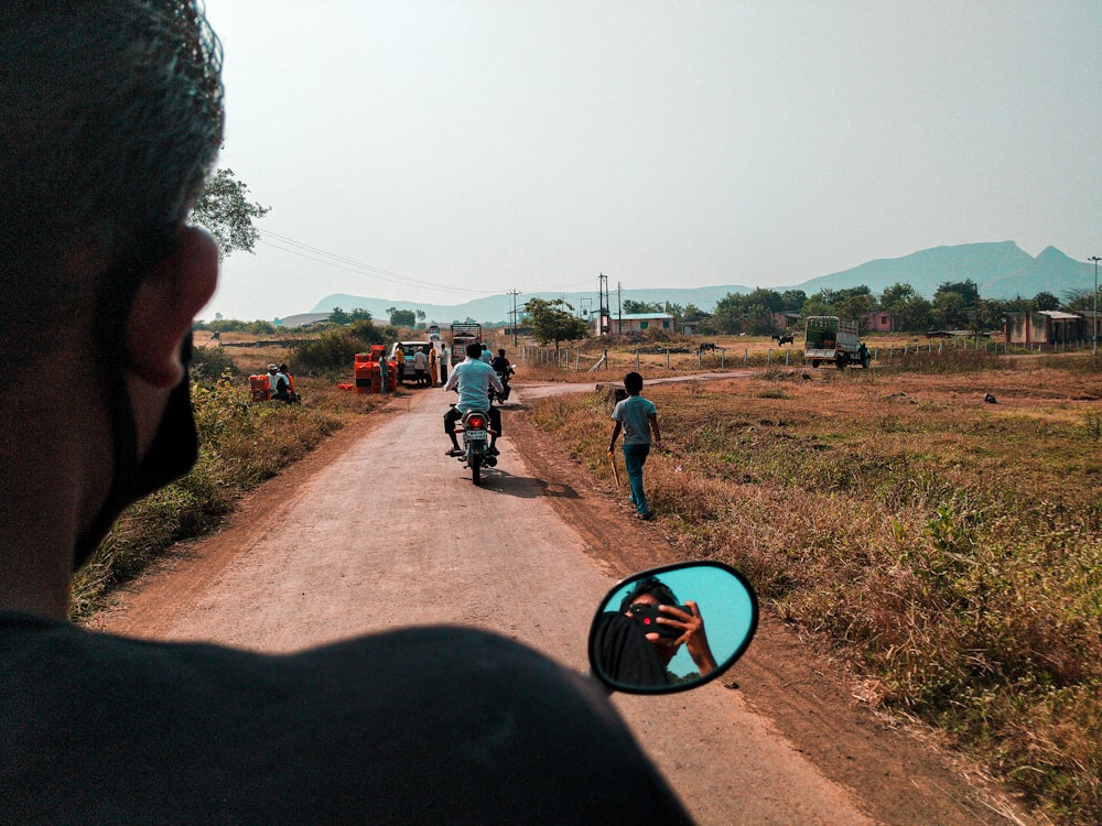 a man taking a picture of a man on a motorcycle