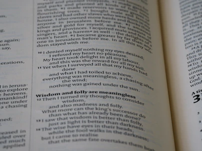 Close-up of a blueprint overlaid on open e-book pages, symbolizing ministry planning.