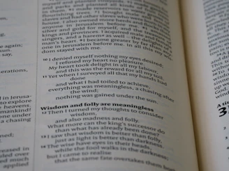 Close-up of a blueprint overlaid on open e-book pages, symbolizing ministry planning.