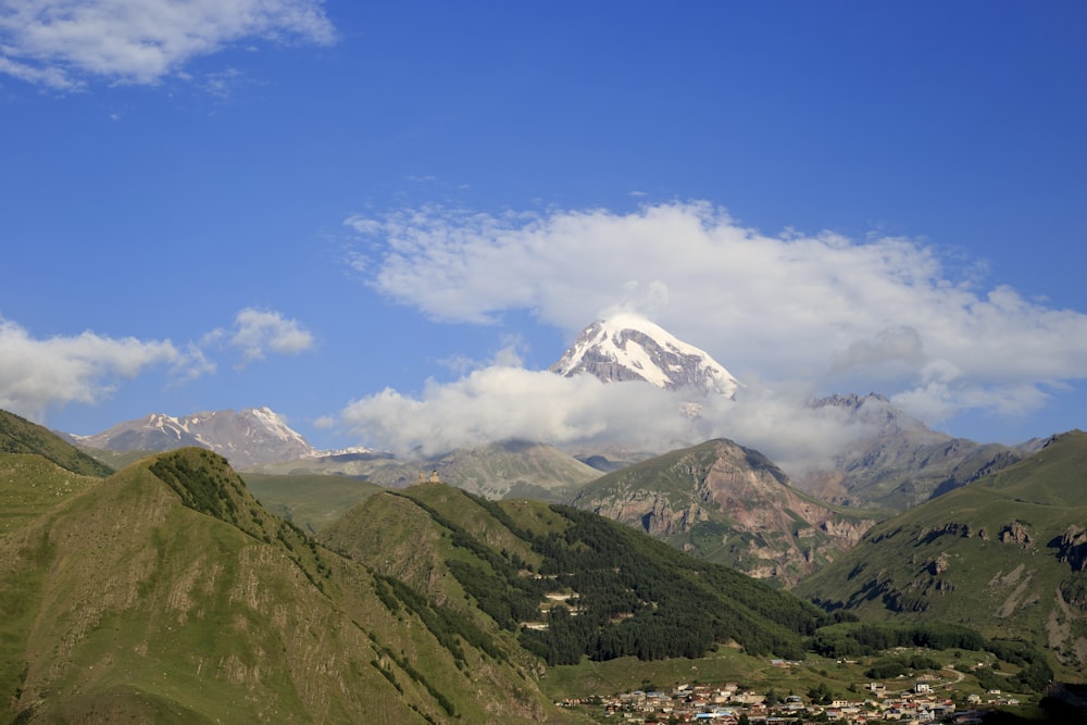 a valley with mountains and clouds