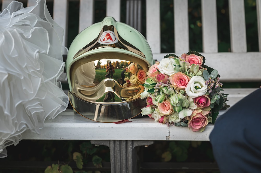 a helmet with flowers in front of it