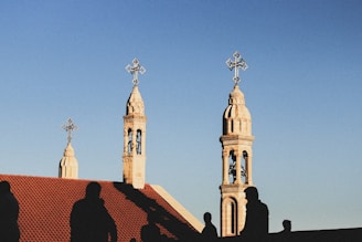 a building with a tower and a cross on top