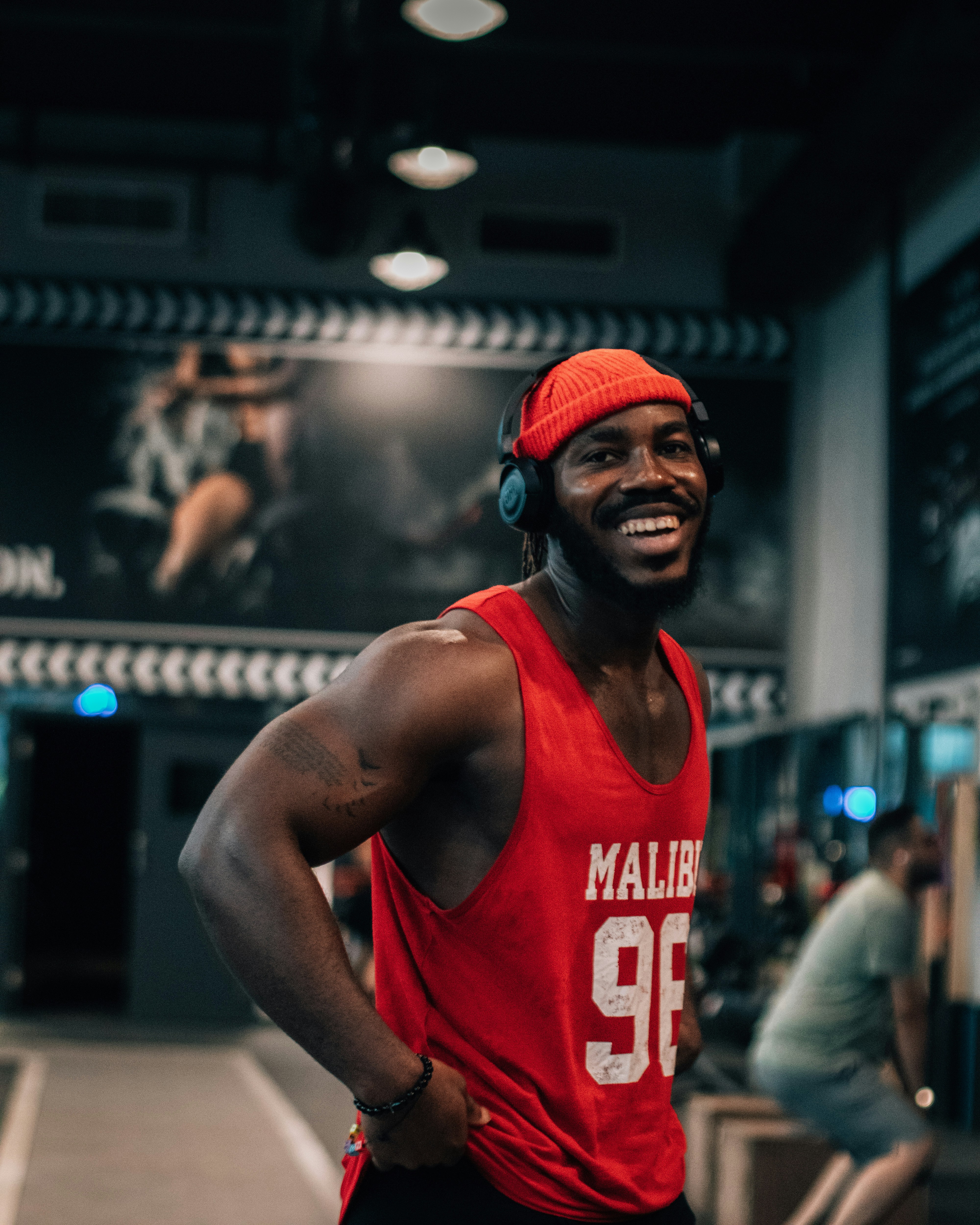 a man wearing a red shirt and headphones