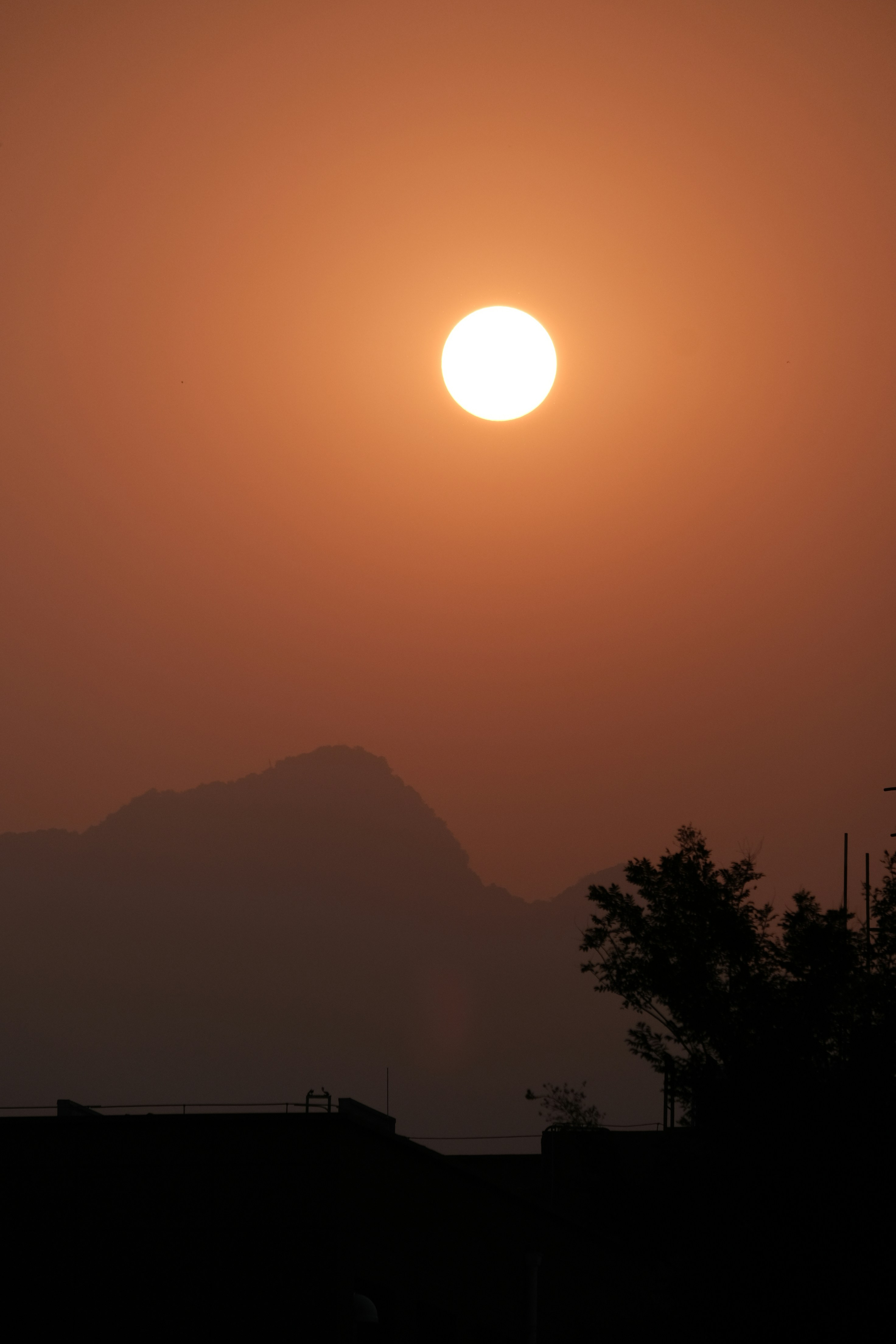a sunset over a mountain