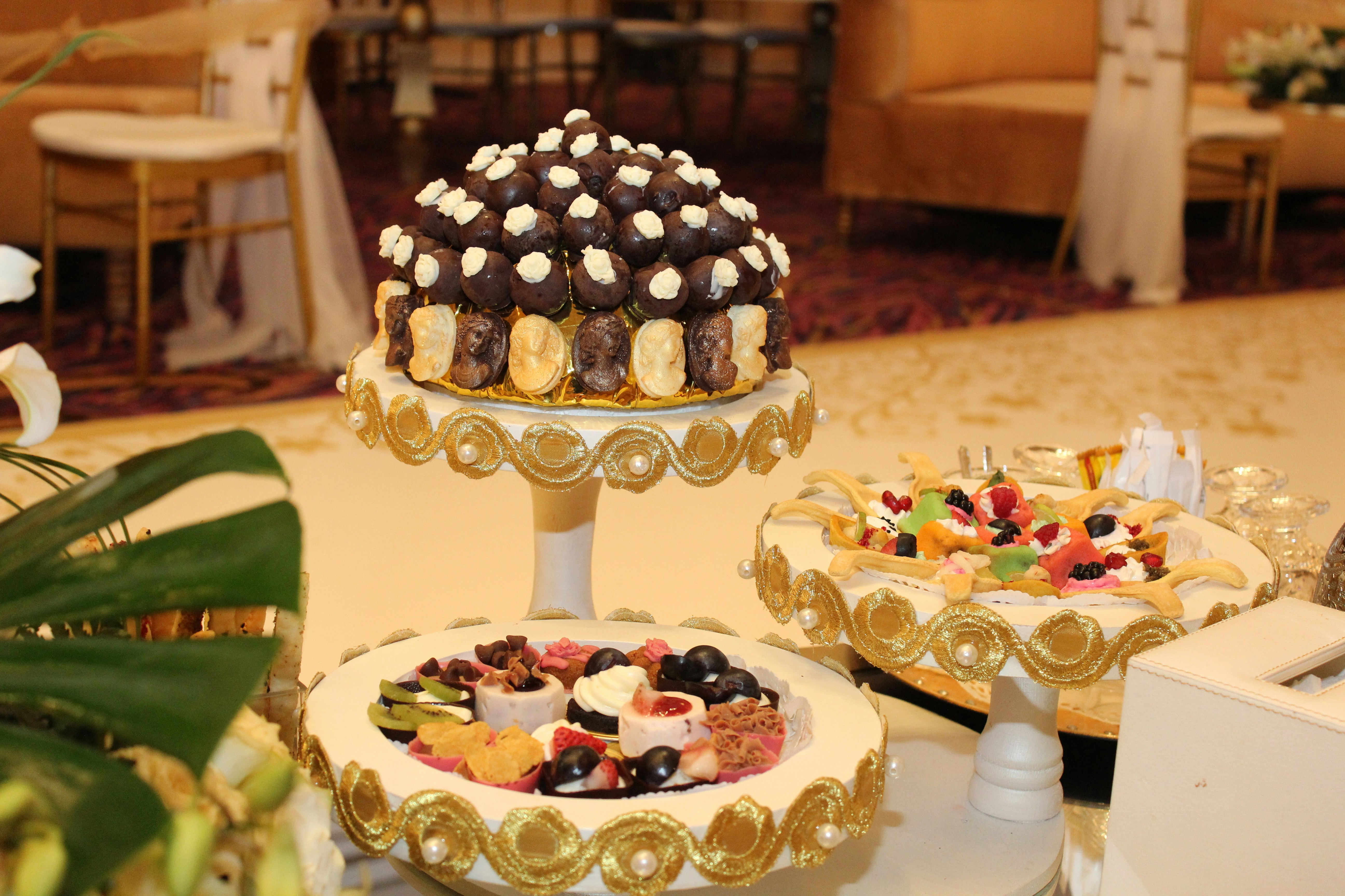 a table with a cake and desserts on it