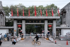a person riding a bicycle under a bridge