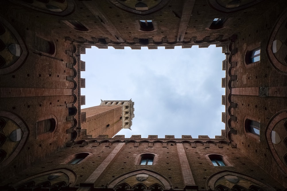 a view looking through a window at a building with a blue sky