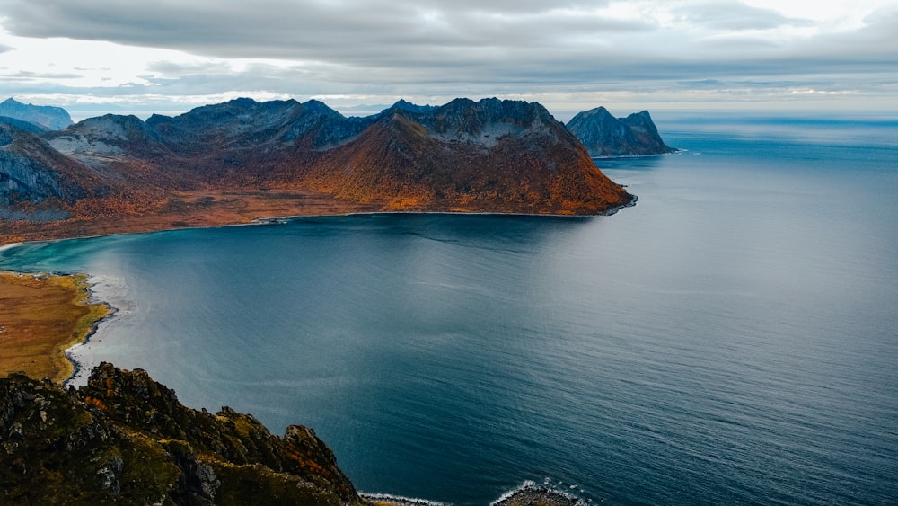 a body of water with mountains in the background