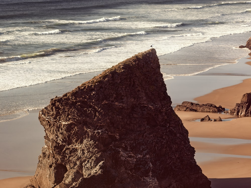 a large rock on a beach