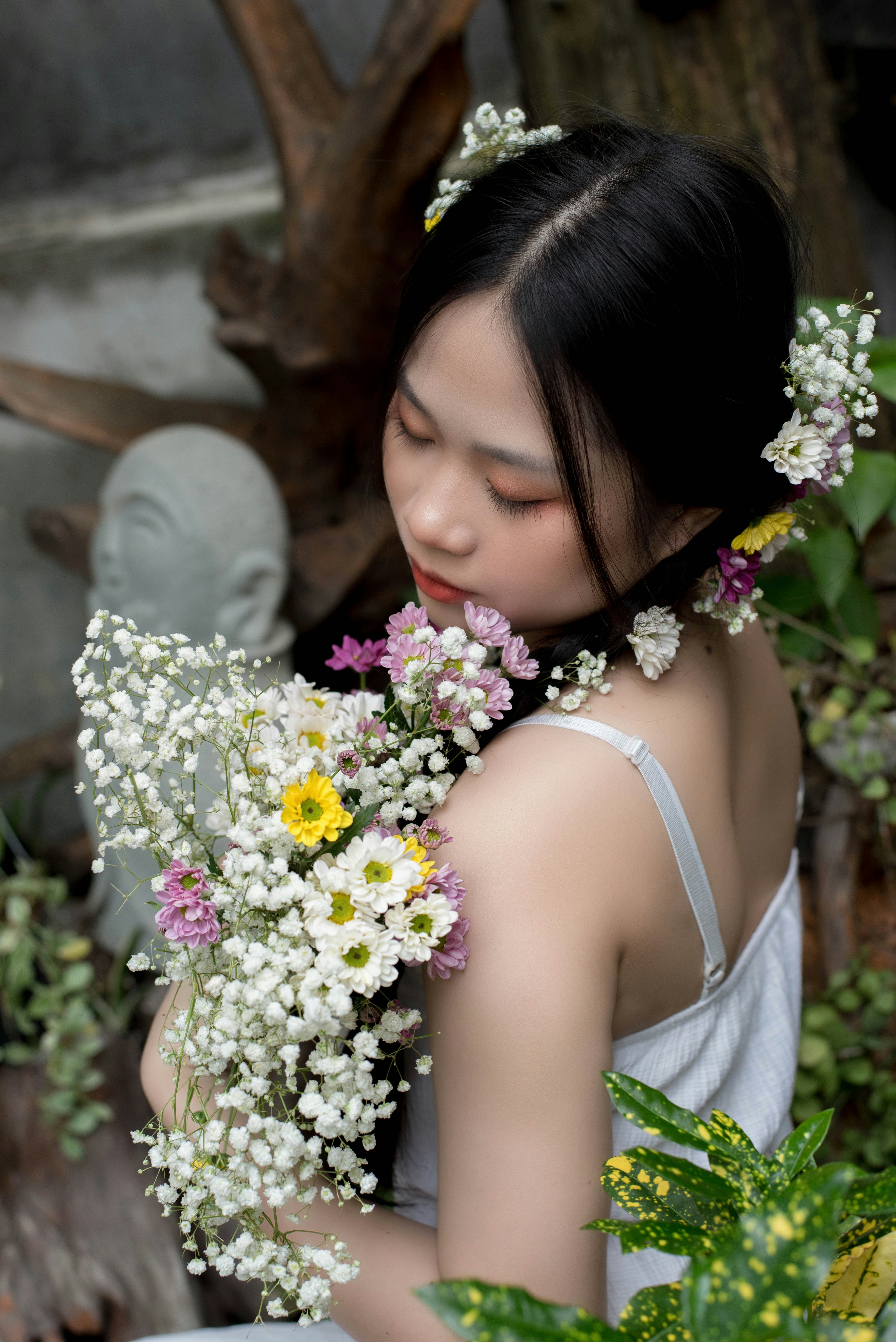 a woman smelling flowers