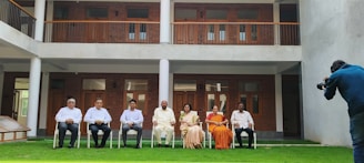 a group of people sitting outside a building