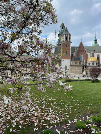 A charming historic national landmark framed by vibrant blooming flowers.