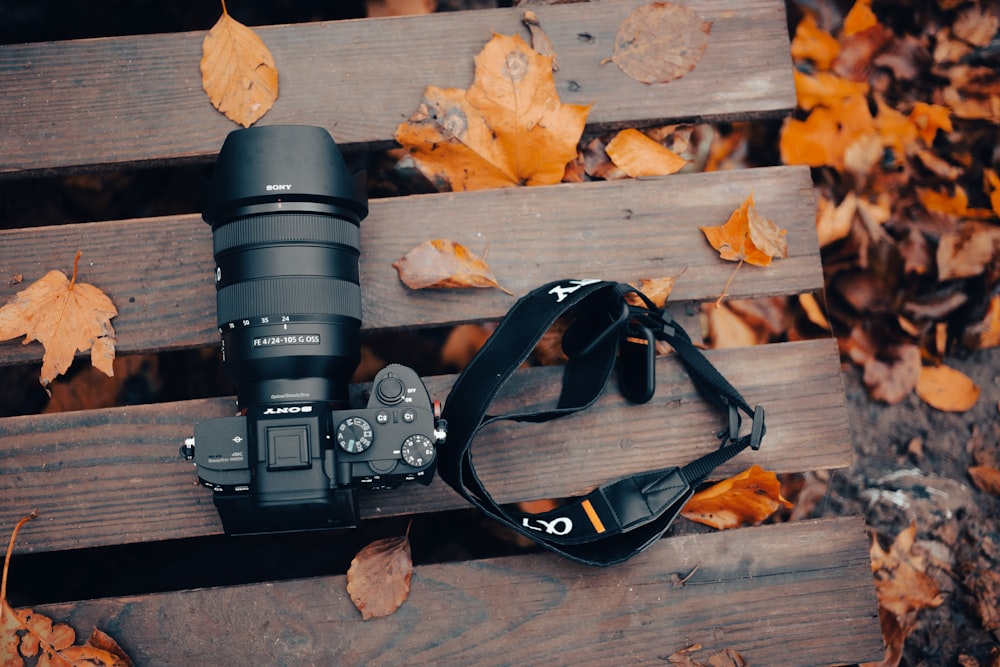 a pair of camera lenses on a wooden surface