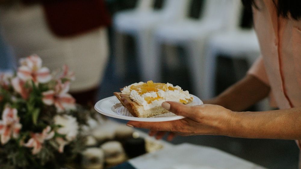 a person holding a plate of food