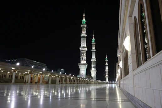 A serene mosque courtyard bathed in soft morning light, with intricate geometric patterns framing the scene.