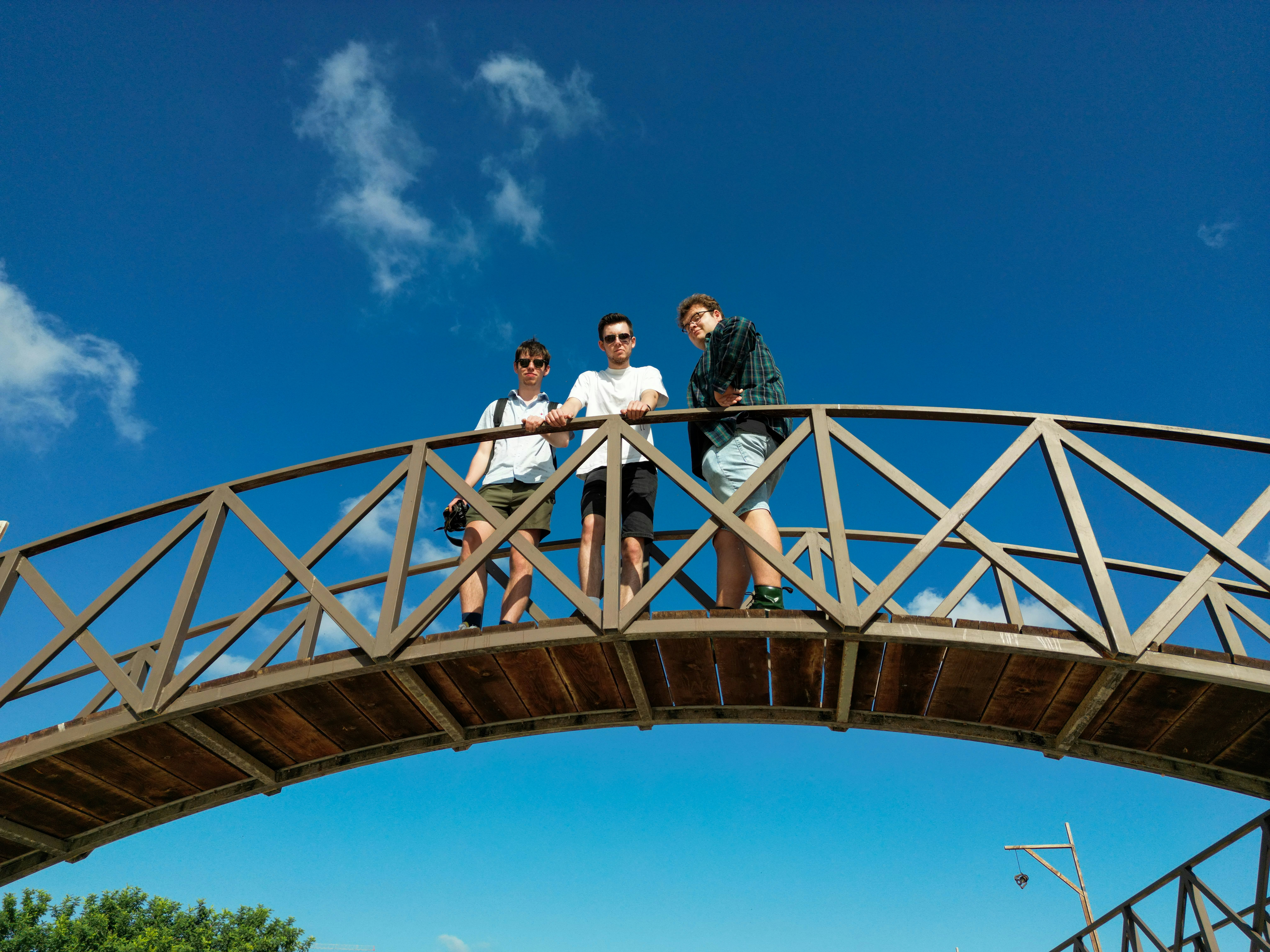 a group of people standing on a bridge