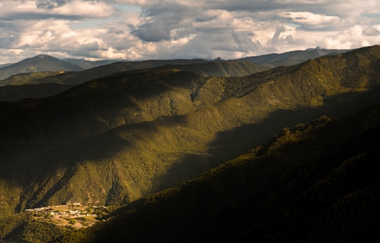 a valley with mountains in the background