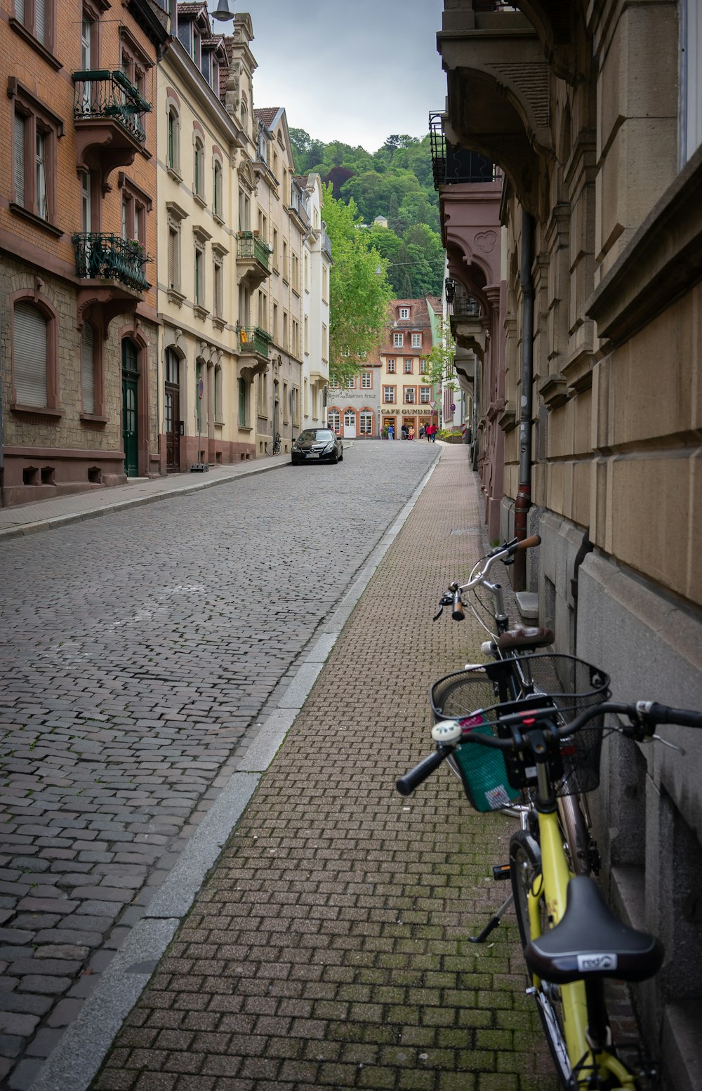 a bicycle parked on a cobblestone street