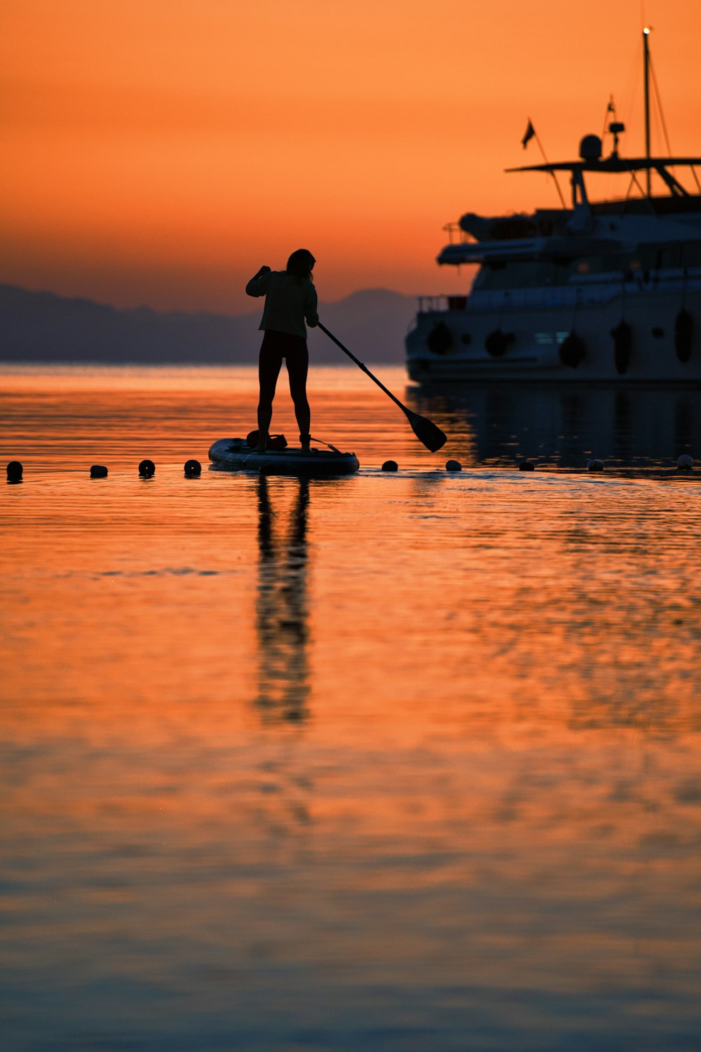 a person paddle boarding on a lake