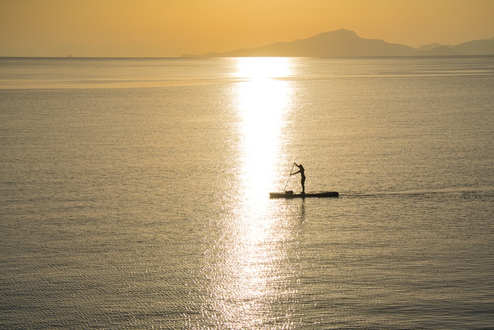 a person on a small boat in the water