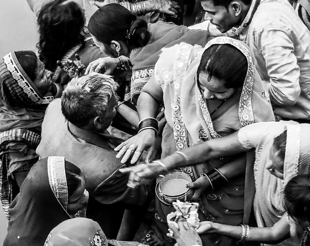 a group of people gathered around a person holding a baby