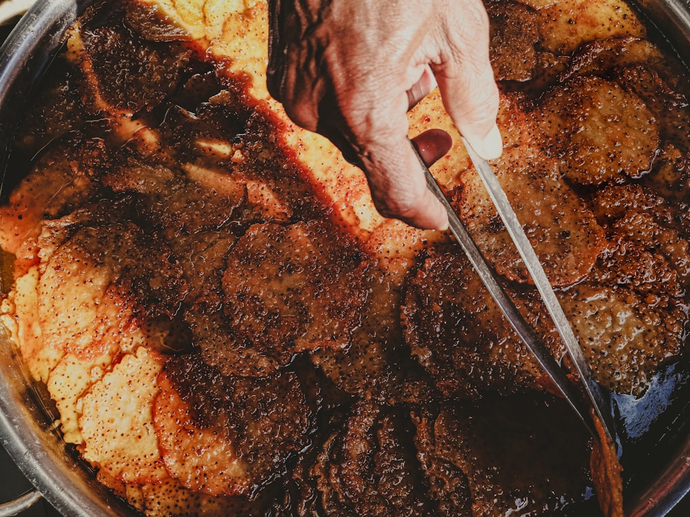 a person cooking food in a pan