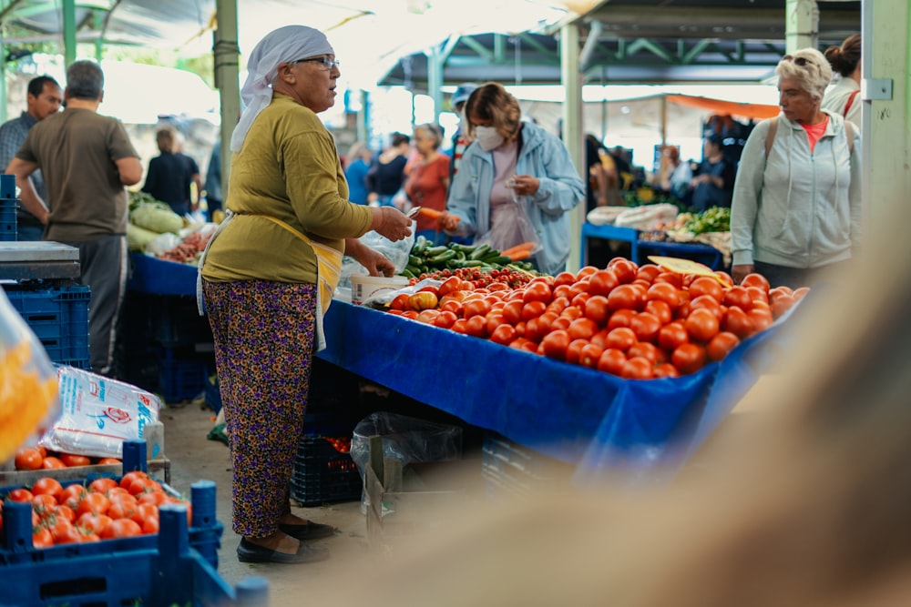 a person buying fruits at a market