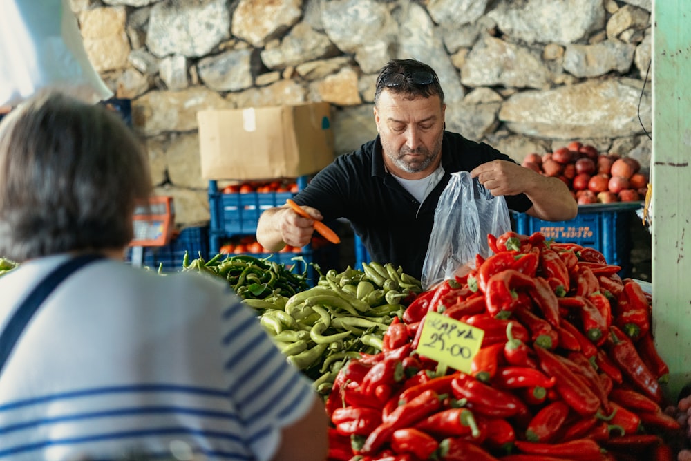a man selling vegetables at a market