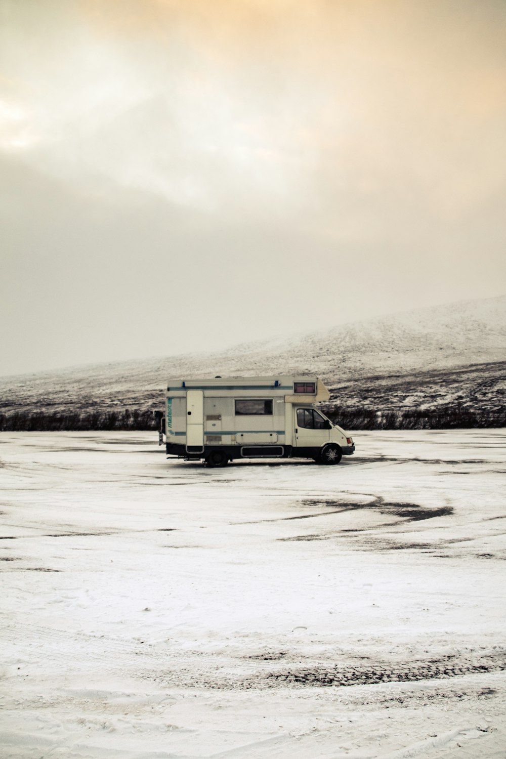 a truck parked in a snowy field