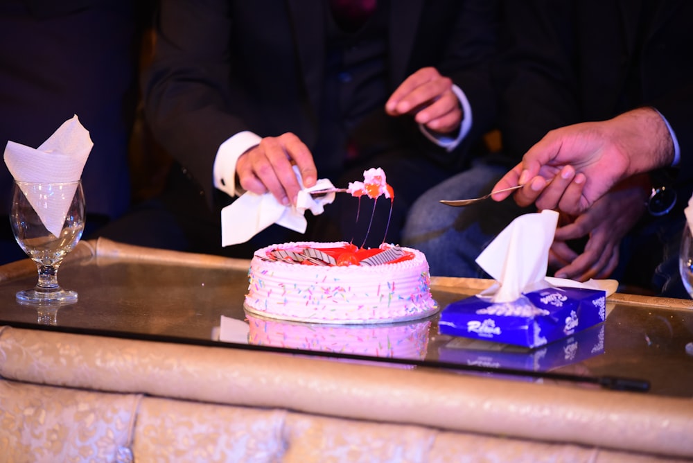 a person cutting a cake