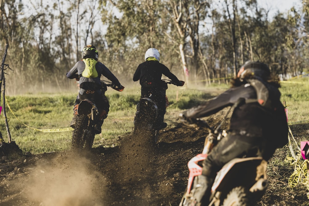 a group of people riding dirt bikes