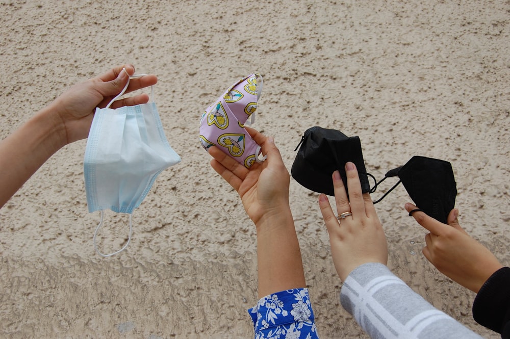 a group of hands holding objects